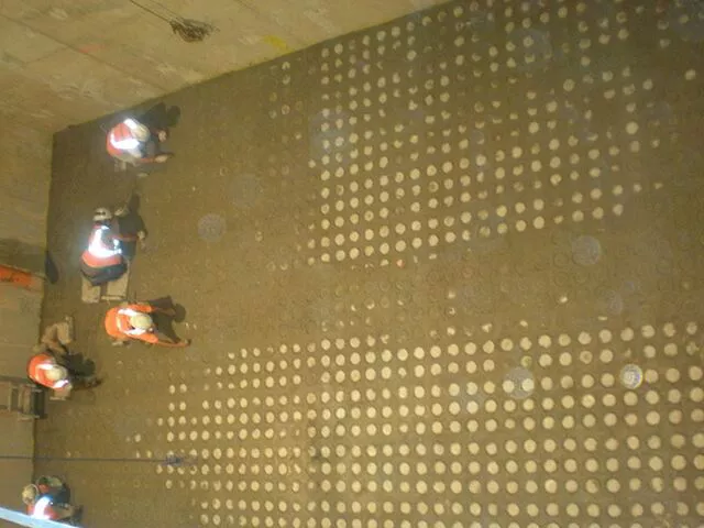 Removing fresh concrete over plastic seating of FlexKleen nozzles inserted into CastKleen Underdrain