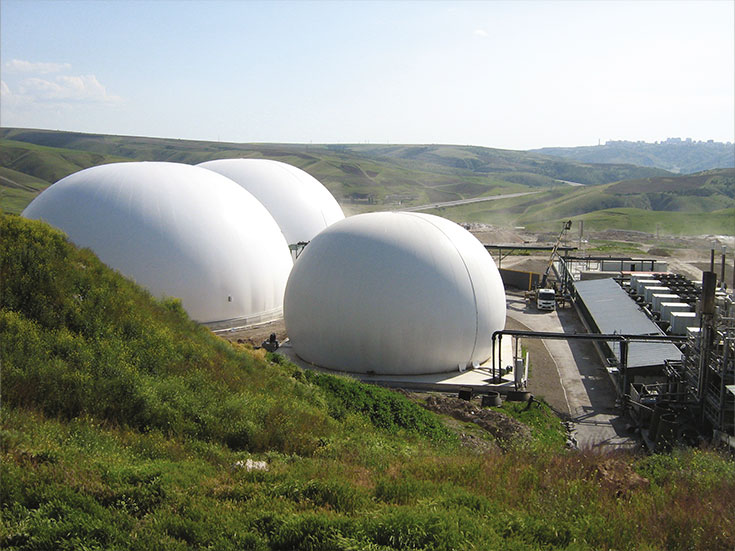Three anaerobic digester covers above tanks store high volume gas for recovery and reuse